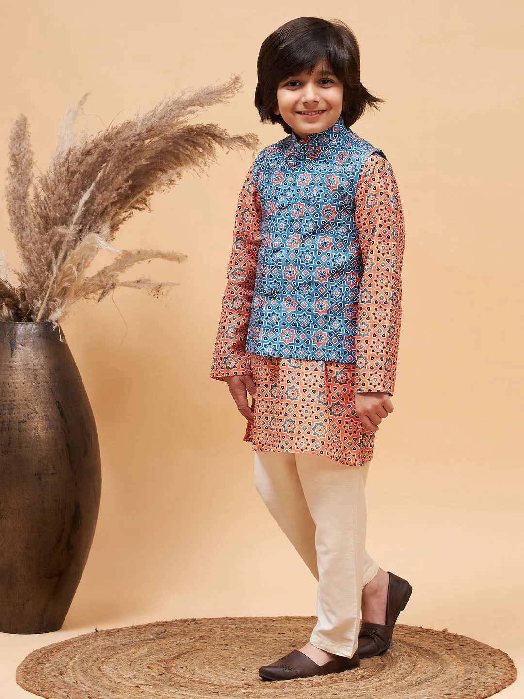 Jashvi Boy's Orange Printed Kurta And Cream Pyjama Set With Blue Nehru Jacket