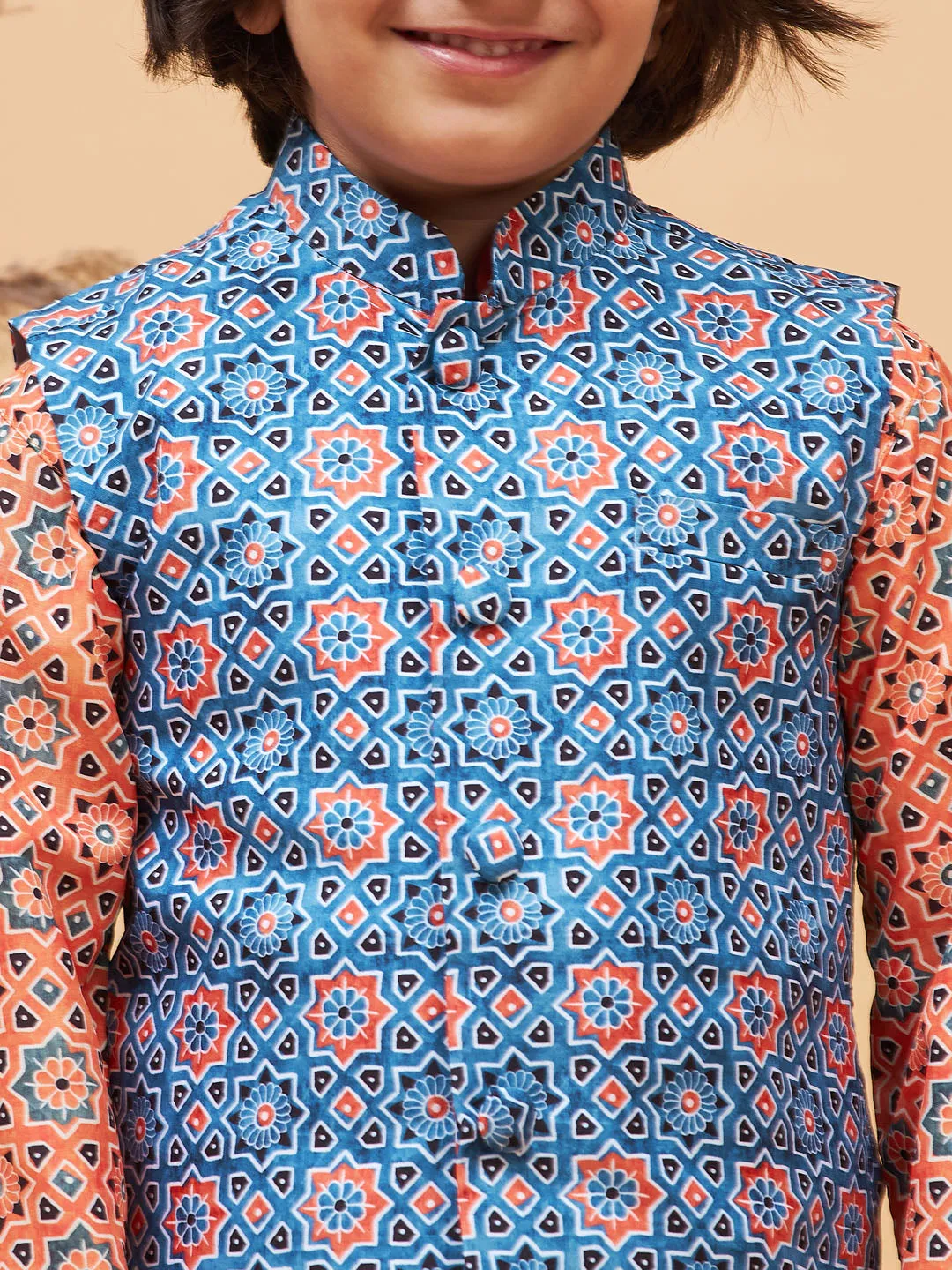 Jashvi Boy's Orange Printed Kurta And Cream Pyjama Set With Blue Nehru Jacket