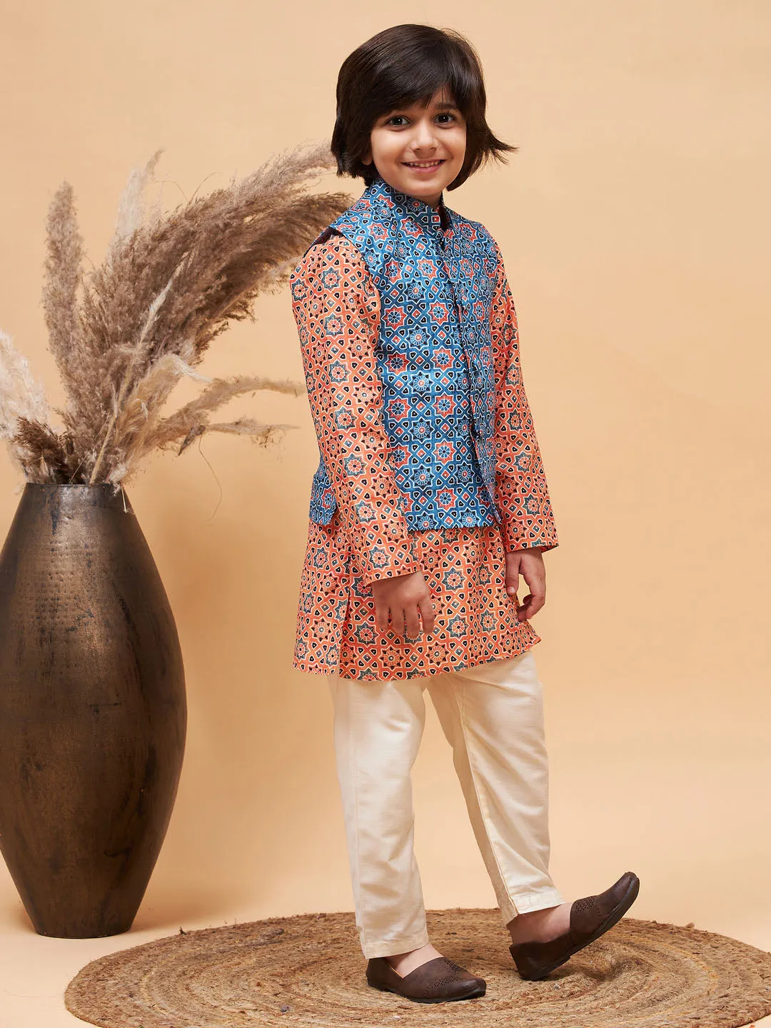 Jashvi Boy's Orange Printed Kurta And Cream Pyjama Set With Blue Nehru Jacket